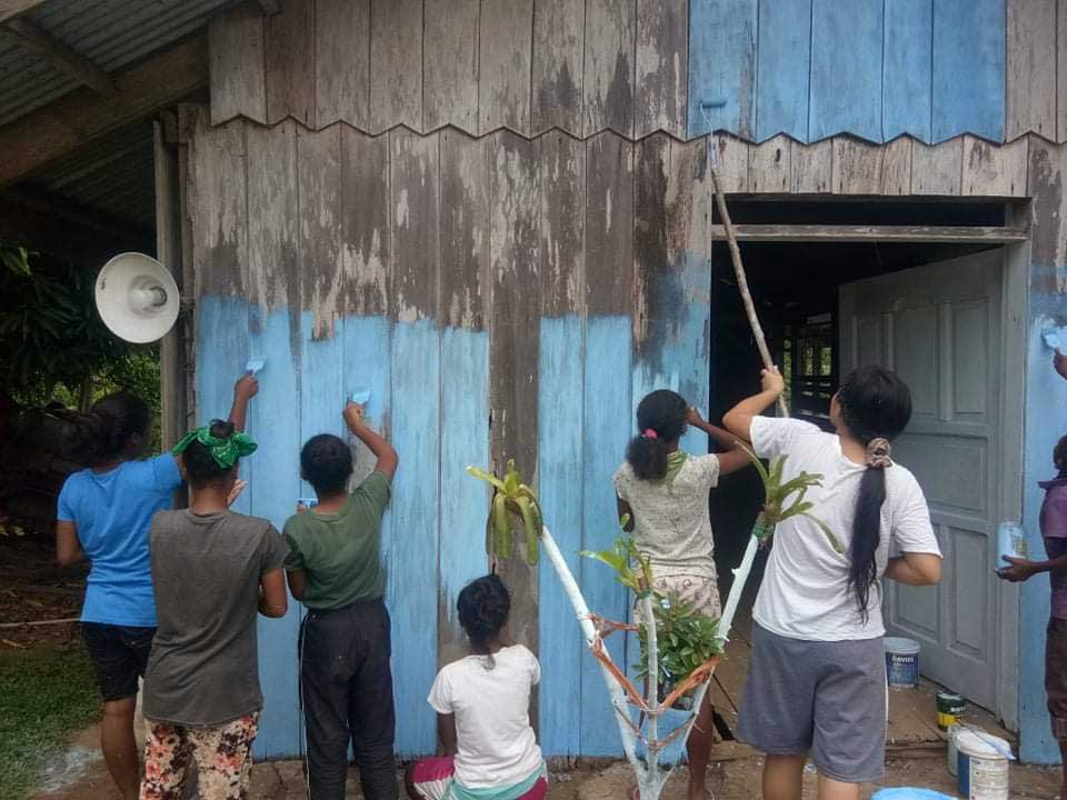 People paining a multi-purpose building People paining a multi-purpose building